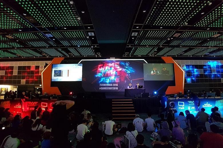 A crowd gathers to watch the finals of the Overwatch tournament. Besides such tournaments, GameStart featured booths by console-makers Sony and Microsoft, where gamers could get hands-on time with the latest games.