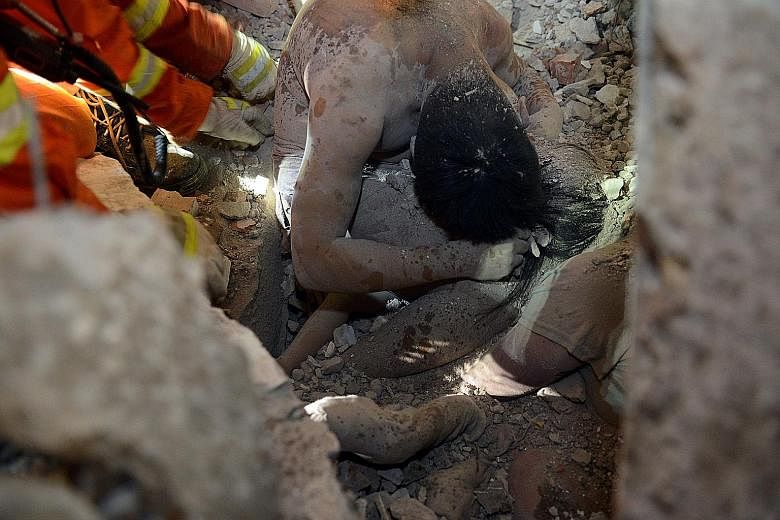 This picture of a man using his body to shield his three-year-old daughter from harm is one of the most touching images to emerge from the building collapse in Wenzhou, in eastern China's Zhejiang province, on Monday. Rescuers found the pair more tha
