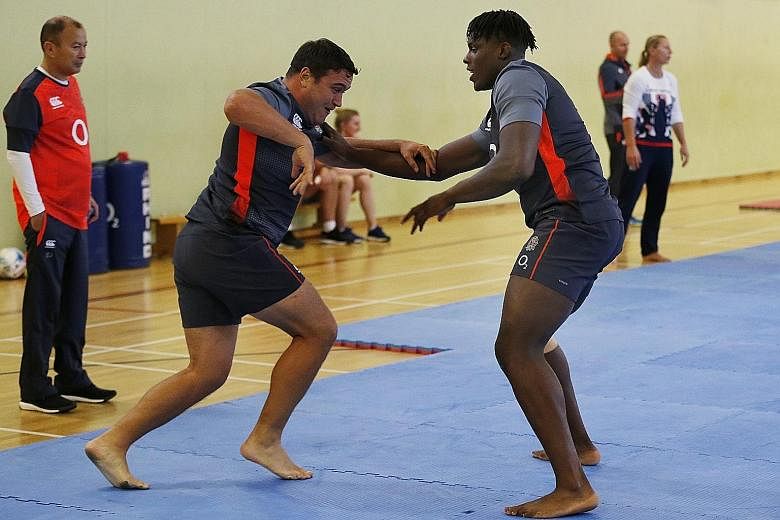 England's Jamie George and Maro Itoje take part in a judo session as head coach Eddie Jones watches on.