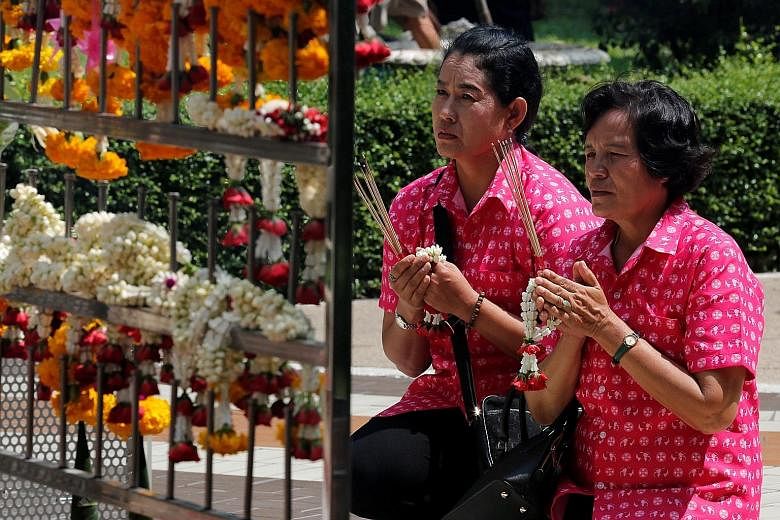 Well-wishers praying yesterday for Thailand's King Bhumibol Adulyadej at Siriraj Hospital in Bangkok, where the monarch is being treated. He has battled a series of ailments in recent years and has not been seen in public since January.