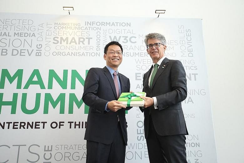 Mr Yeoh and Mr Fischer at the opening yesterday of Mann+Hummel's first global Internet of Things lab. Mr Fischer says that smart air filtration systems could help Singapore manage the haze.