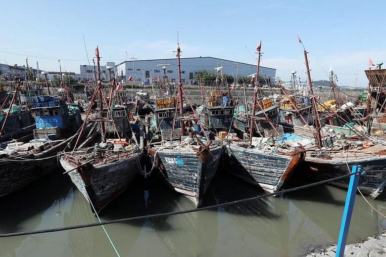 Chinese fishing boats that were seized after being caught operating illegally in South Korea's exclusive waters moored at a port in Incheon, South Korea. The South Korean coast guard plans to relax its rules on the use of firearms.