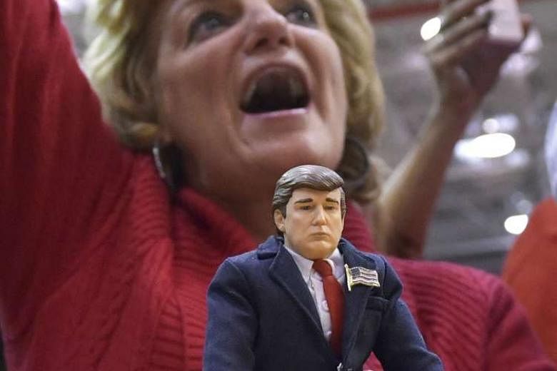A supporter holding a Trump doll at a rally in Pennsylvania. The presidential campaign has presented an image of a troubled, divided and deluded US to the rest of the world. 