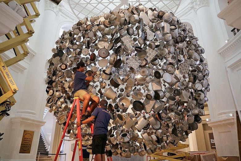 Cooking The World, by Indian artist Subodh Gupta, is one of the 60 works in the biennale. Dislocate by Vietnamese artist Bui Cong Khanh features delicate carpentry carved over two years.