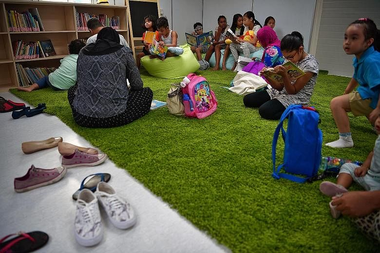 Children enjoying the temporary library that opened in Punggol West this month. Among the children-centric plans for the estate are a toy library for toddlers and storytelling sessions run by stay-home mums.