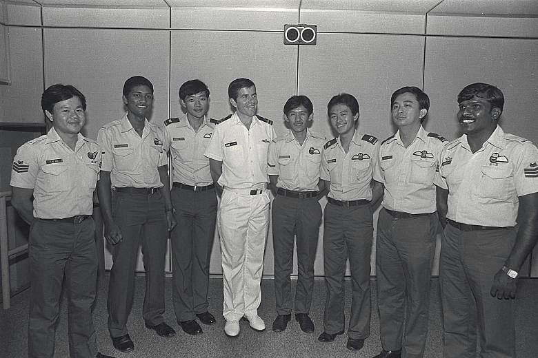 Above: Mr Ledger (fourth from left) in a 1983 photo with members of the cable car rescue team. Right: The 60-year-old, who has since retired from active duty as a commodore, was invited to aluncheon for PM Lee yesterday.