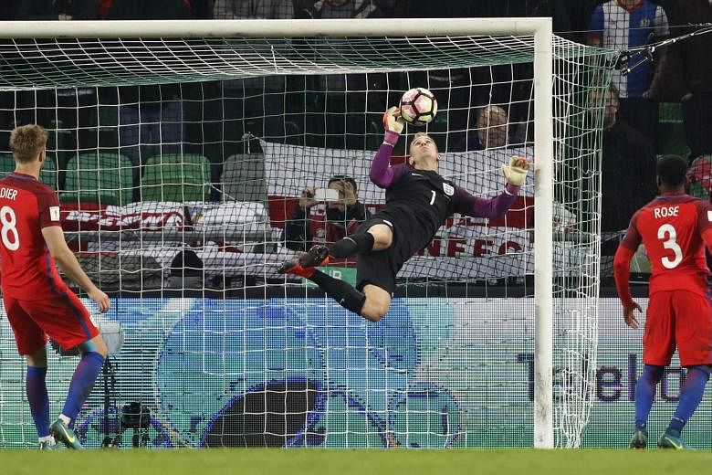 England midfielder Eric Dier watches as Joe Hart claws away a goalbound effort. Hart's saves earned England a 0-0 draw in Slovenia.