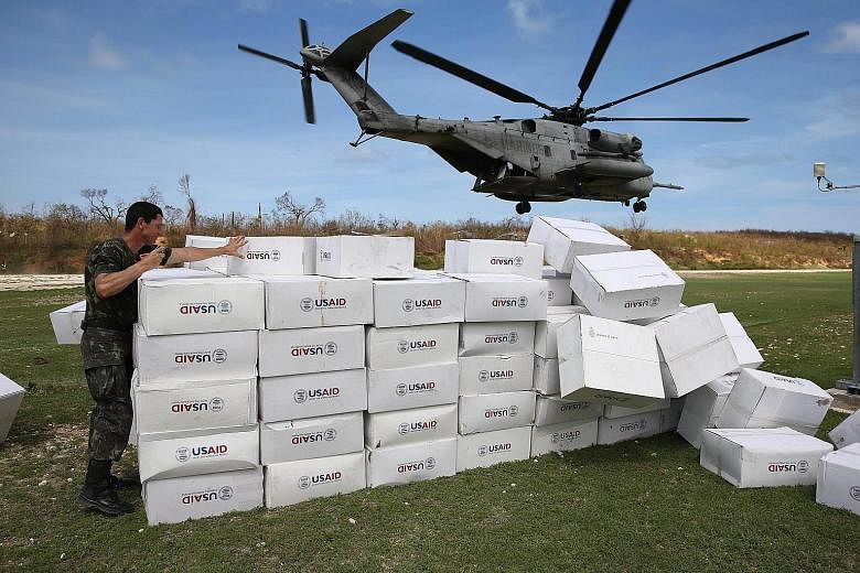 A US military helicopter taking off after unloading humanitarian aid for the Haitian city of Jeremie, which was left devastated by Hurricane Matthew.