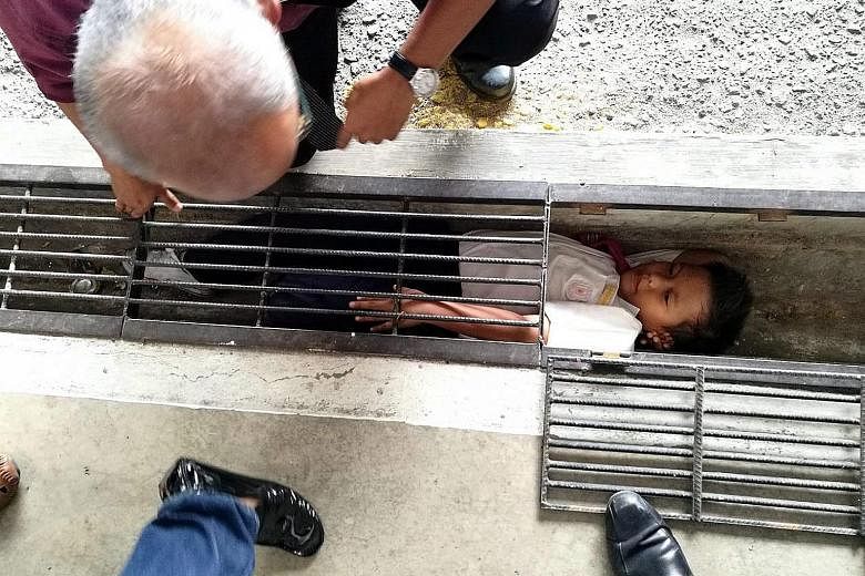 An eight-year-old boy got stuck in a drain on Tuesday in Klang, in Selangor, Malaysia, while trying to retrieve RM1 (33 Singapore cents). The boy's ordeal, which lasted about 20 minutes, happened in Sekolah Kebangsaan Batu Belah. The pupil's pocket m