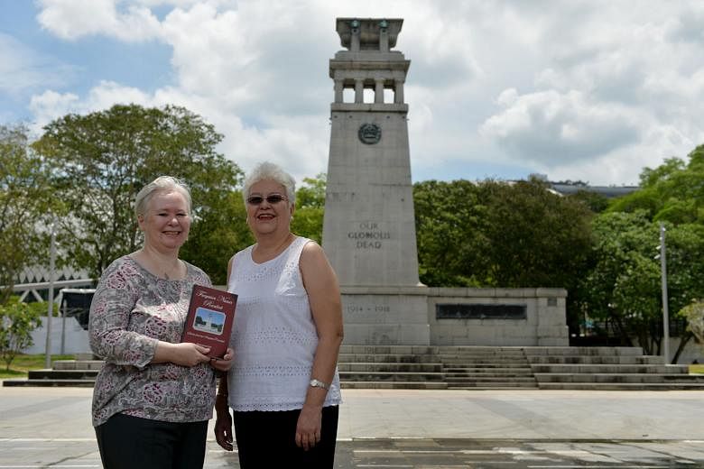 Above: Mrs Lim (left), author of a book about the people behind the names inscribed on the Cenotaph, seen in the background of this picture, with Ms Clarke, grand-niece of one of the fallen men mentioned in the book.
