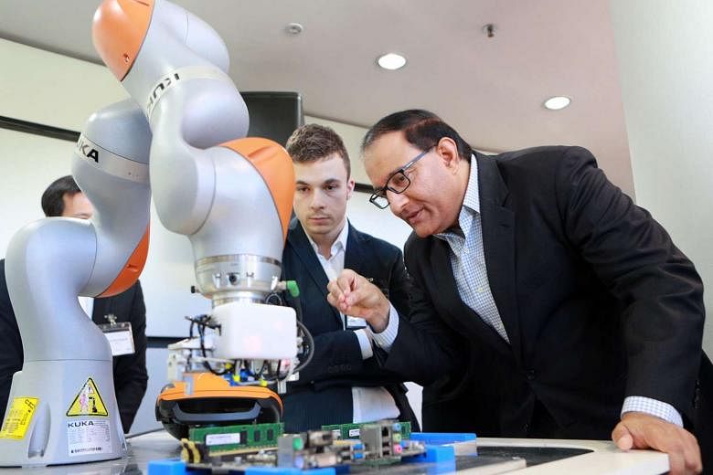 Mr Iswaran takes a closer look at robotics technology displayed by one of Meiban's partners at the Meiban Innovation Centre. Meiban Group has begun to digitalise its factory operations through what it calls the iSmart Factory project. 