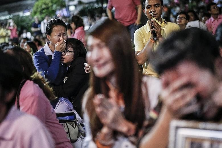Thais reacting to the announcement of King Bhumibol's death outside the Siriraj Hospital yesterday. A Royal Palace statement issued in Bangkok yesterday said that the King, 88, died in the hospital. During his reign, the well-loved monarch had create