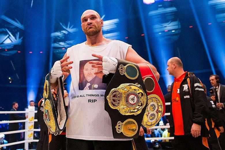 Tyson Fury celebrating after his win over Wladimir Klitschko in their world heavyweight title bout in Germany last November. Fury on Wednesday announced that he would vacate his WBO and WBA titles in order to focus on getting medical help. The Briton