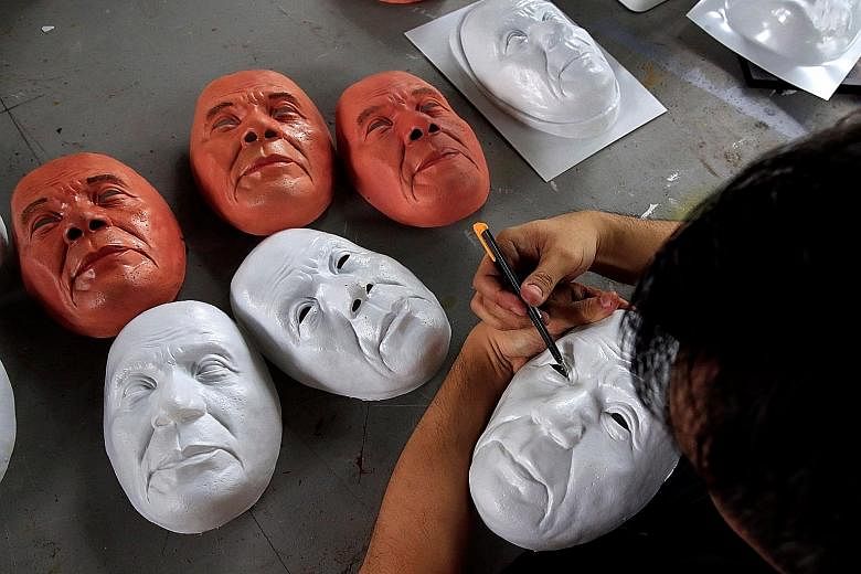 An unfinished Halloween mask depicting Philippine President Rodrigo Duterte being trimmed by industrial engineer and professor John Tan at the College of Fine Arts of the University of the Philippines in Quezon City, Metro Manila, yesterday.