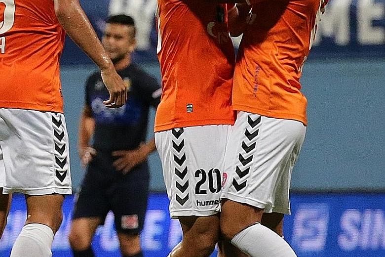 Rui Kumada (centre) is the toast of his team-mates after putting Albirex 3-0 up against Hougang in the 32nd minute. That the White Swans would clinch the league title was in little doubt after that.