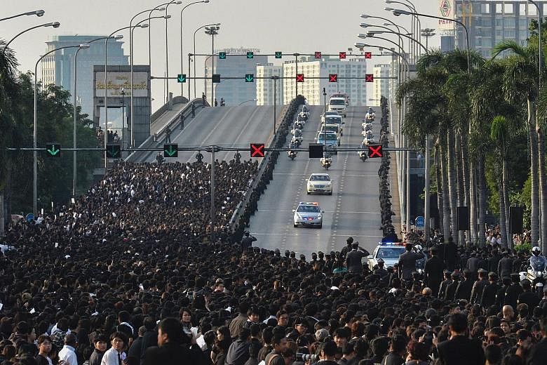 Thais lining the streets to pay their respects as the royal convoy carries the body of King Bhumibol from the Siriraj Hospital, where he died on Thursday, to his riverside Grand Palace in Bangkok. The city was in a sombre mood as Thailand began a yea