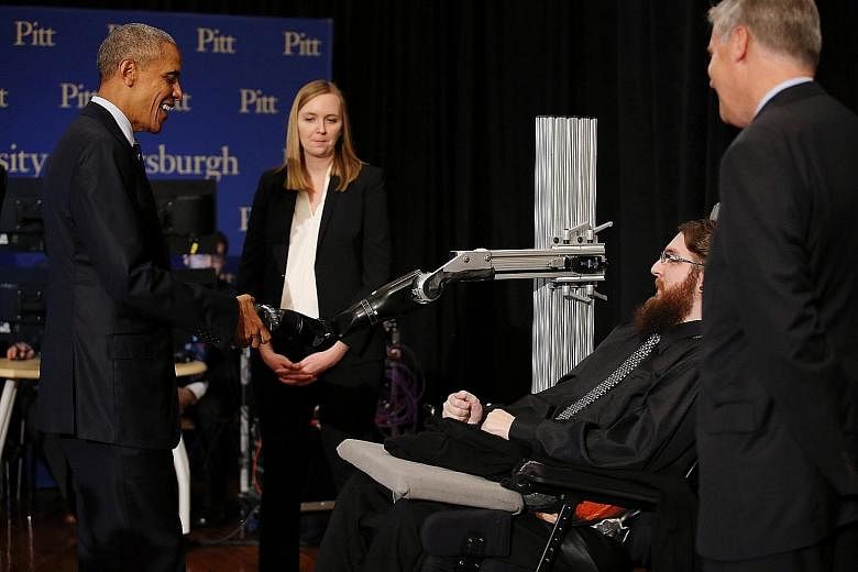 President Obama shaking hands with a robotic arm operated by Mr Copeland at the White House Frontiers Conference in Pittsburgh. When Mr Copeland was blindfolded during an experiment, he could identify correctly the location of the sensation when the 