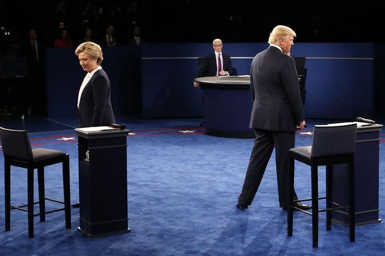 Mrs Clinton and Mr Trump at the second presidential debate on Sunday. The vitriolic war between the two threatens to hurt the reputation of the United States abroad, and has already likely damaged domestic political discourse for some time to come. 