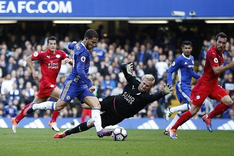 Chelsea's Eden Hazard about to score their second goal past Leicester goalkeeper Kasper Schmeichel. The comprehensive victory was just what Antonio Conte needed after recent speculation about his job security. As for the Foxes, their title defence ha