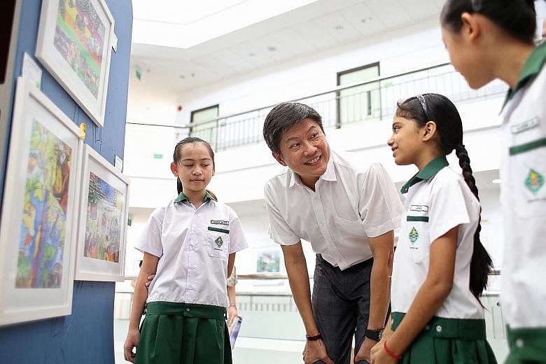 Mr Ng at an art exhibition yesterday at the Nanyang Community Club, where students from schools in the area displayed their work.