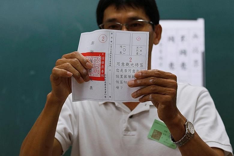 An official counting a "no" vote yesterday in the referendum on casino development on the island of Penghu, Taiwan. The proposal was overwhelmingly rejected by 81 per cent of the voters.
