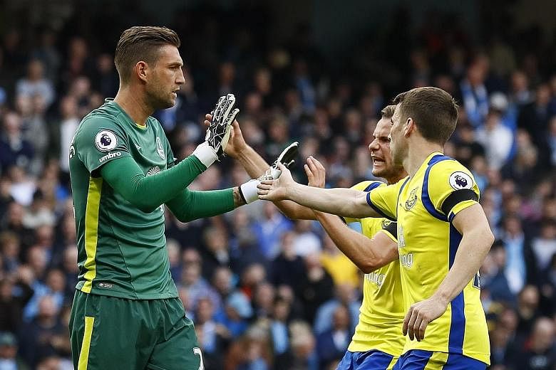 Everton's Maarten Stekelenburg (left) had a stellar game, saving a penalty from Kevin de Bruyne in the first half and guessing right for the second time when he dived low to his left in the second half to save another penalty from Manchester City's S