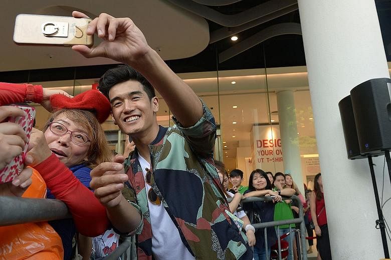 Hartono with his former Chinese tutor Jin Zi Lan, 57, at the meet-and-greet session. For nearly two hours, he crooned, signed autographs, handed out cups of Milo to the crowd and played stage games with fans. Hartono with the Milo crew and fans at Bu
