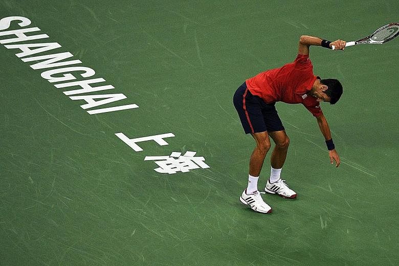 Novak Djokovic smashing his racket during his 6-4, 6-4 defeat by Roberto Bautista Agut of Spain in the semi-finals of the Shanghai Masters yesterday. "I knew I could not go on playing at the highest level for so many years all the time," said the Ser