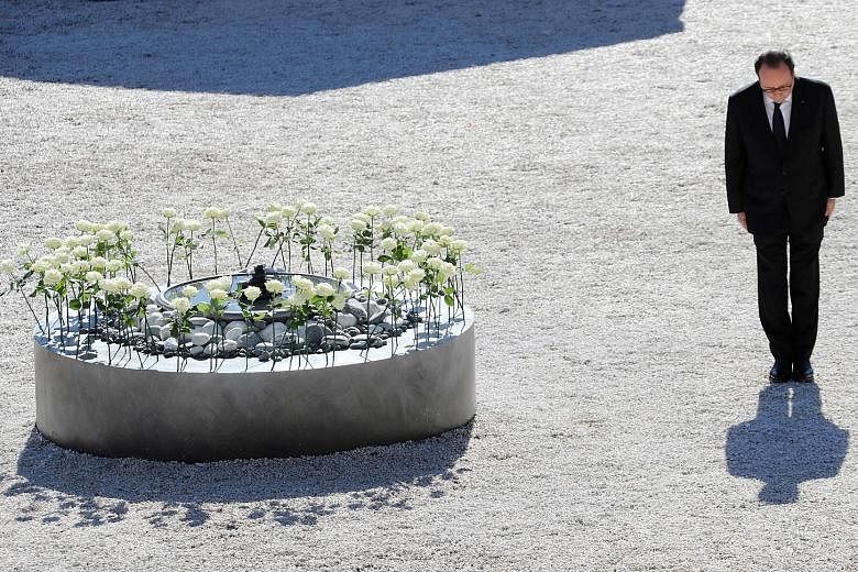French President Francois Hollande yesterday in Nice during a tribute to the Bastille Day terror attack victims. The white roses represent the 86 people who died on July 14.