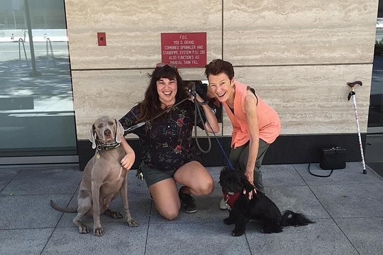 Ms Billie Greer (right) with dog-walker Sonja Mendoza. At the age of 78, Ms Greer, co-founder of public affairs consulting firm Greer Dailey, moved into a downtown Los Angeles high-rise apartment.