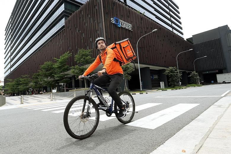 Mr Fazli, a Foodpanda cyclist, says riding a bicycle is more flexible as he can use the pavement to avoid traffic.