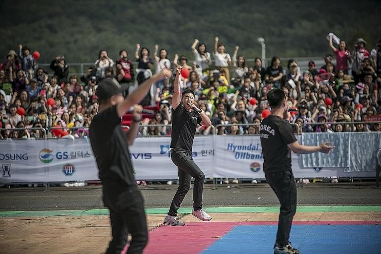 U-Know Yunho (centre), a soldier and one of South Korea's most famous K-pop stars, performing at a military festival.