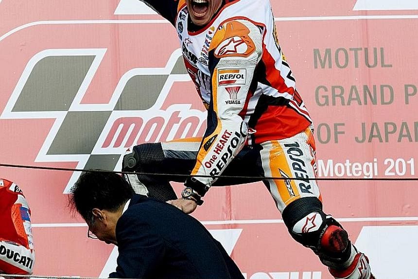 Above: Honda rider Marc Marquez, winner of the Japanese Grand Prix in Motegi, had never won at Honda's home circuit before yesterday's race. Left: Marquez leading Italian MotoGP Yamaha duo Valentino Rossi (left) and Jorge Lorenzo during the Japanese 