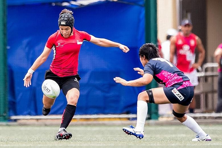Singapore women's captain Alvinia Ow Yong (left) in action against Japan in the Hong Kong leg of the Asia Rugby Sevens Series last month. Japan won that match 45-0 and went on to be crowned series champions.