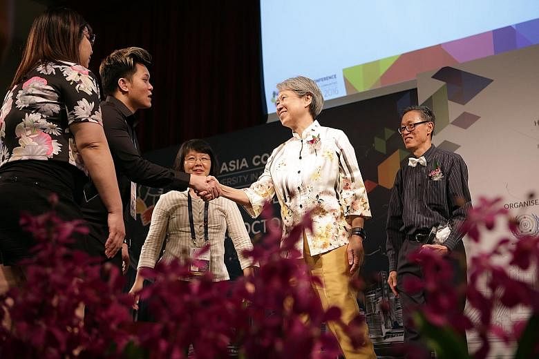 Ms Ho, patron of the Singapore Association for the Deaf, with members of the organising committee on stage. With her is Mr Lim Chin Heng (extreme right), chairman of the World Federation of the Deaf organising committee.