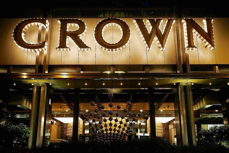 Left: Crown casino in Melbourne. Crown shares fell 14 per cent, their biggest one-day decline. Above: Billionaire James Packer, who owns 53 per cent of Crown Resorts. The company said it had not made contact with its 18 employees, including Australia