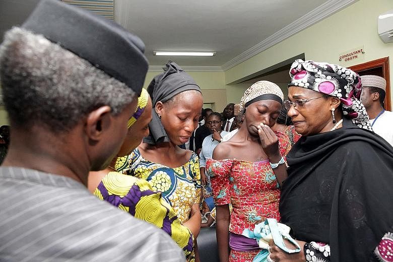 Some of the 21 released Chibok schoolgirls at a gathering in Abuja, Nigeria, last Thursday. As many as 276 girls were taken in April 2014 when Boko Haram militants stormed a boarding school.
