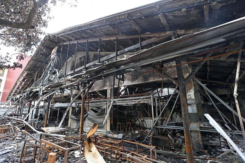 The gutted shell of the wet market at Block 493, Jurong West Street 41, after it was engulfed in a fire last Tuesday. 