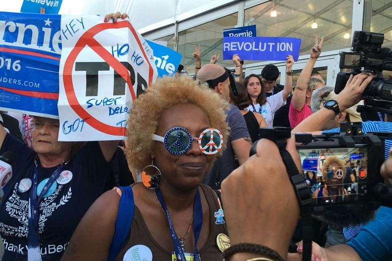 An anti-TPP protester at a July rally for Democratic presidential contender Bernie Sanders. The party's nominee, Mrs Hillary Clinton, backed the TPP before turning against it under pressure from Mr Sanders.