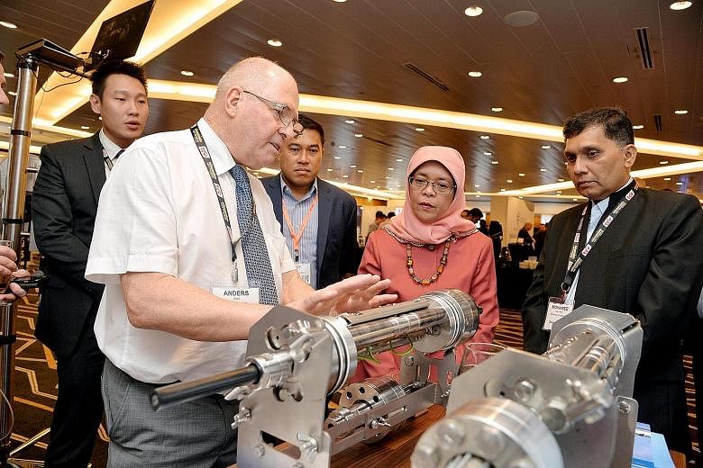Madam Halimah Yacob touring exhibition booths at the event yesterday with (from right) Mini Environment Service Group founder and chief executive Mohamed Abdul Jaleel and Sacofa managing director Zaid Zaini.