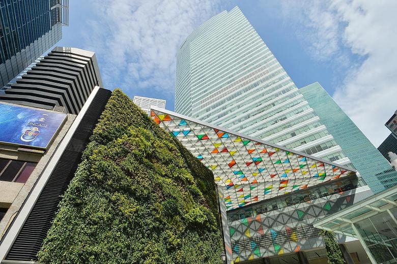 Higher income from Ocean Financial Centre (left, with green wall facade) and better results from its associates helped cushion the blow in the third quarter for Keppel Reit.