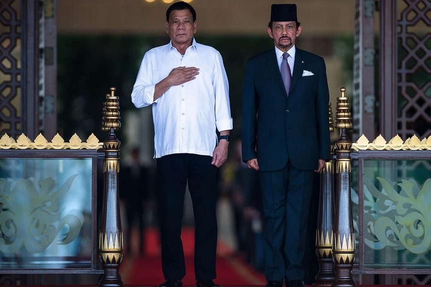 Philippine President Rodrigo Duterte (far left) and Brunei's Sultan Hassanal Bolkiah at Mr Duterte's official welcoming ceremony at the Istana Nurul Iman in Brunei. Mr Duterte arrived in Beijing last night after a three-day state visit to Brunei.