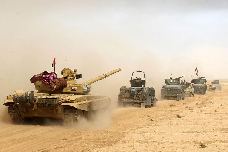 Iraqi forcesin al-Shurah, some 45km south of Mosul, on Monday as they advanced towards the city to retake it from militant group Islamic State in Iraq and Syria. 