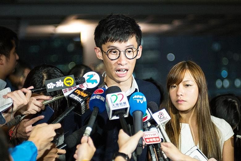 Pro-Beijing lawmakers walking out of the Hong Kong legislature yesterday in protest against the swearing-in of pro-independence lawmakers Baggio Leung and Yau Wai Ching (both below, speaking to the press on Tuesday).