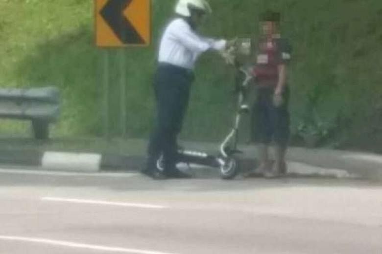 Above: A Land Transport Authority officer stopping an e-scooter rider who had been speeding on Tuesday in Upper Aljunied Road. 
