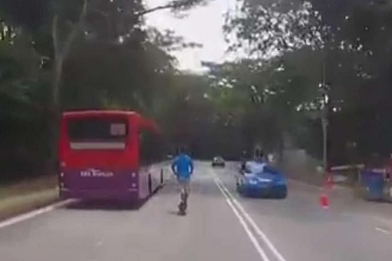 Above: An e-scooter user is seen riding beside a bus along Aljunied Road in a video taken last Friday that went viral. 
