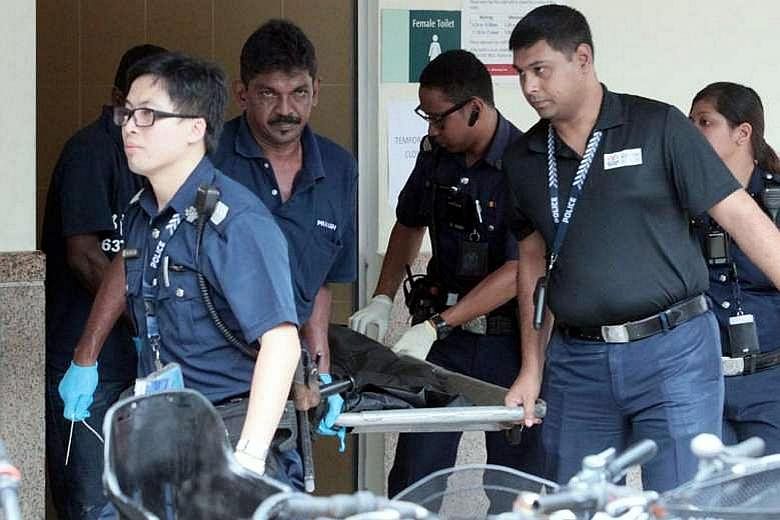 Police officers seen carrying a body bag from a toilet at Tampines MRT station on June 3, where the body of a newborn baby boy was found. An open verdict was recorded at an inquest into the infant's death.