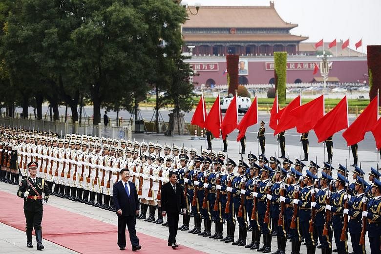 Mr Xi and Mr Duterte reviewing the honour guard during a welcome ceremony for the Philippine President in Beijing yesterday. Mr Duterte highlighted warm ties, calling China "a friend of the Philippines".