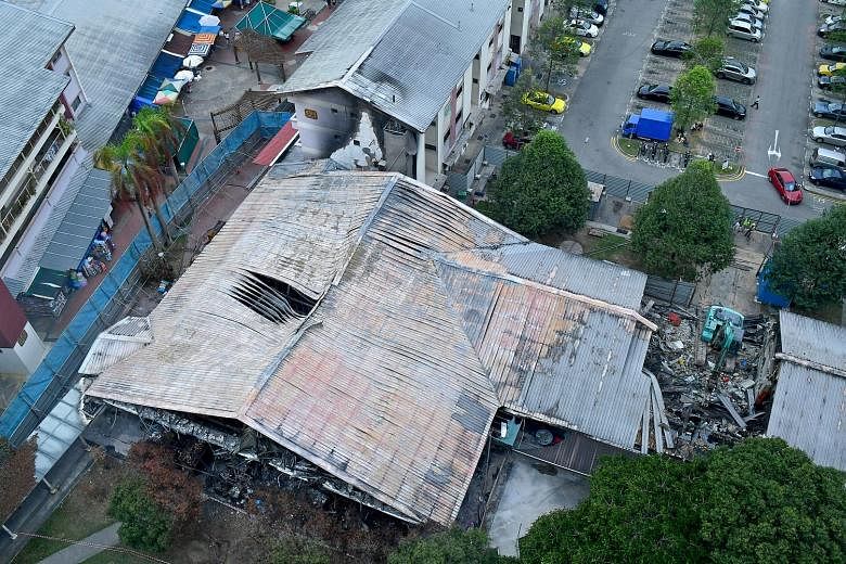 Demolition work was under way yesterday at Block 493, Jurong West Street 41 - housing a wet market and a coffee shop - that was badly damaged in a fire last week. The Housing Board said on Wednesday that the process will take about three weeks to com
