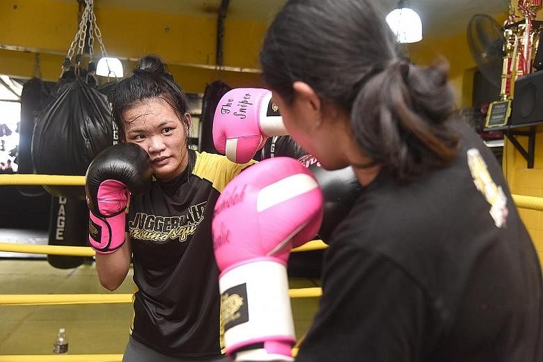 Mixed martial arts fighter Tiffany Teo (left) and Nurshahidah Roslie, Singapore's first female professional boxer, training ahead of their respective fights next month. Teo will take on Walaa Abbas at ONE: Defending Honor while Nurshahidah will face 